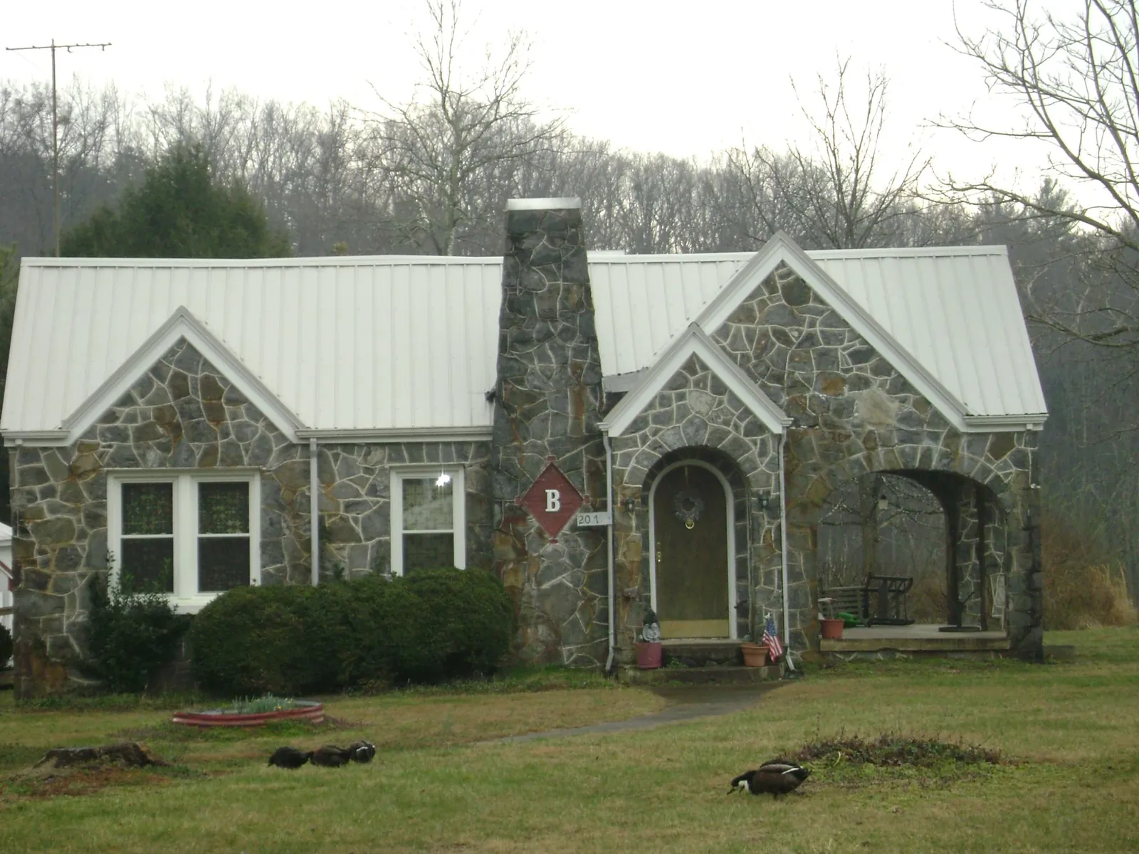 White metal roof on a stone cottage with steep gables in Hatfield