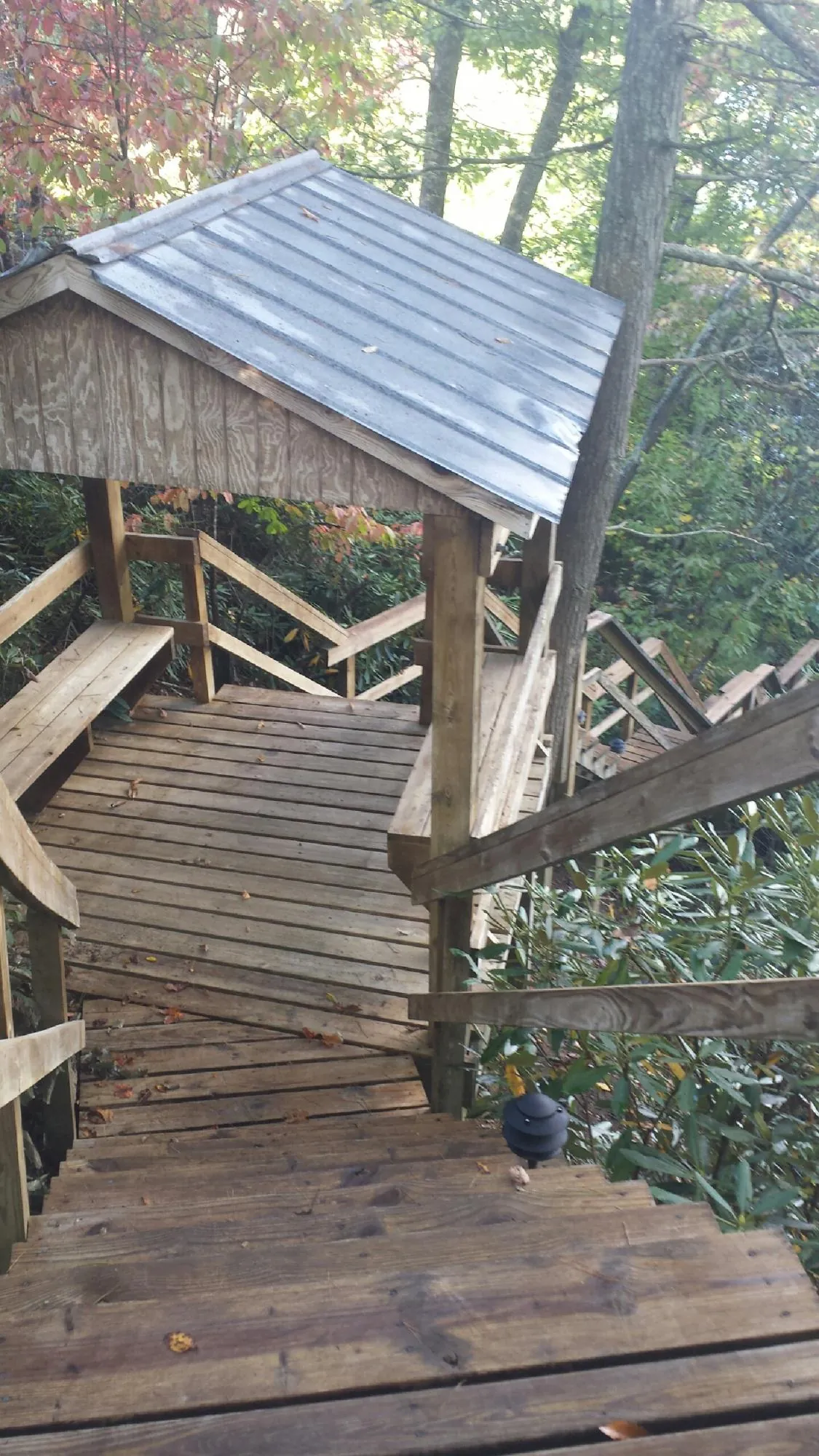 Metal roofed shelter over wooden steps on a wooded walkway — Skylight Repair & Installation work by our crew in Hatfield