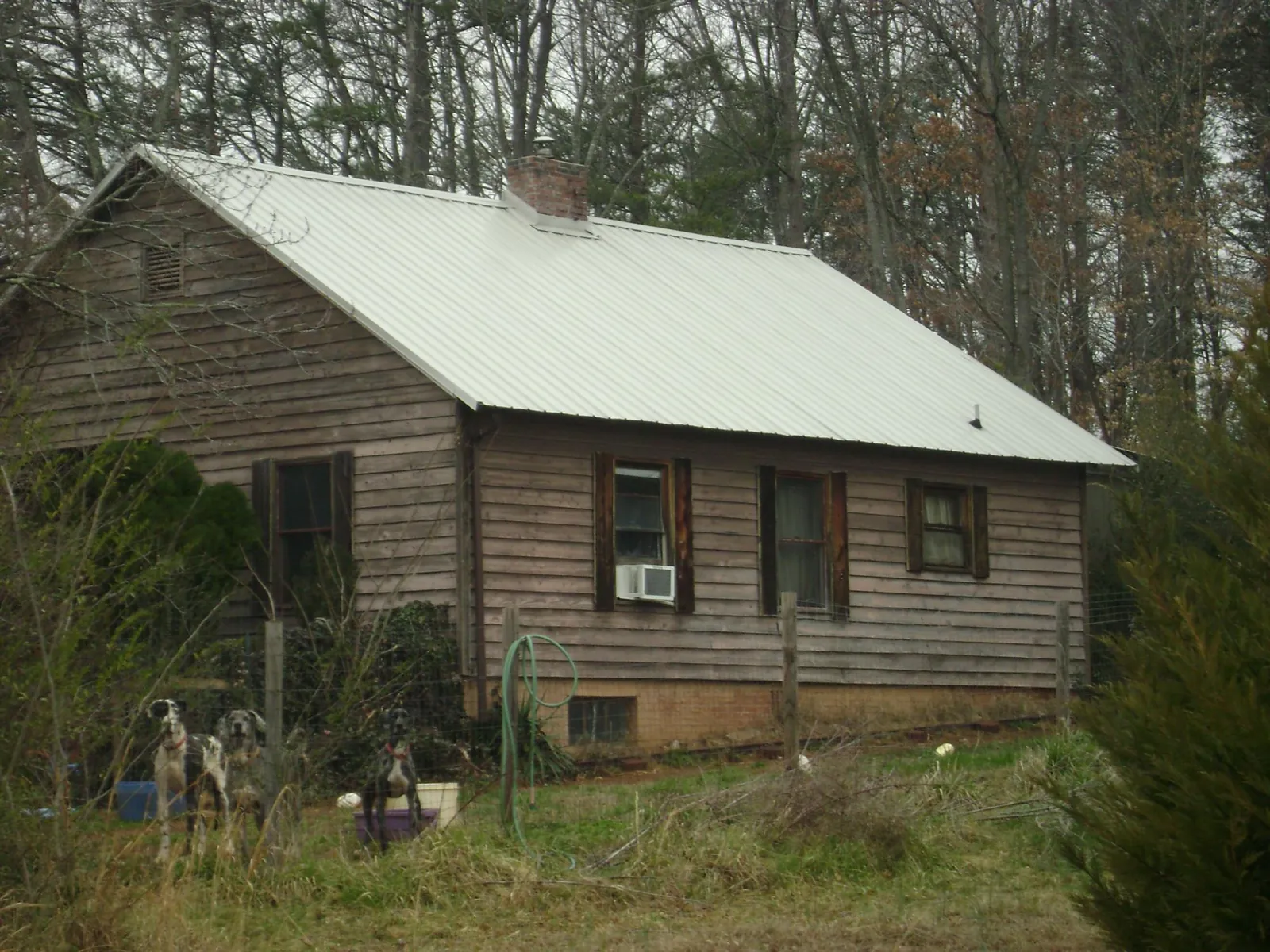 White metal roof on an old wood sided farmhouse, from a Metal Roof Installation job in Hatfield
